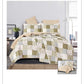 Patchwork quilt set on a bed with pillows in a bedroom setting
