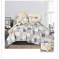 Patchwork quilt set on a bed in a bedroom setting
