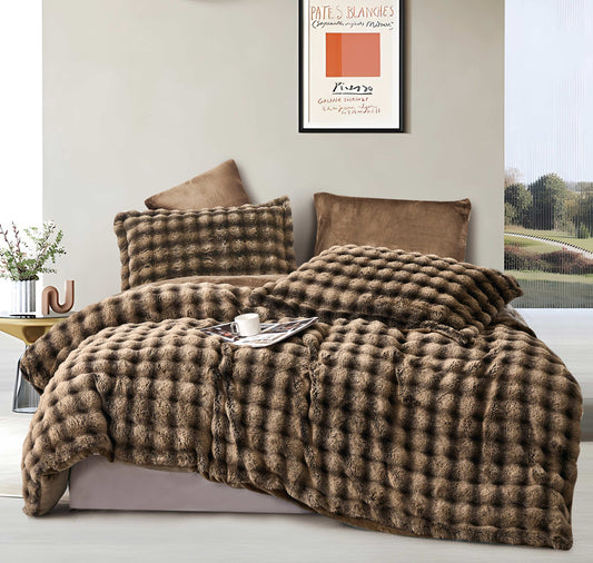 A brown quilted comforter set on a bed, with accompanying pillow shams, displayed in a bedroom setting.