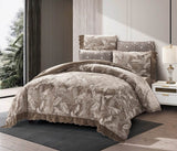 A floral lace-trimmed flannel comforter set in beige and brown colors, displayed on a bed with matching pillows and bed skirt.