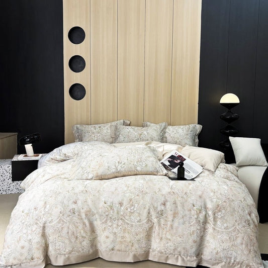 A luxury duvet cover set with a floral pattern, displayed on a bed in a bedroom setting with wooden headboard and bedside tables.