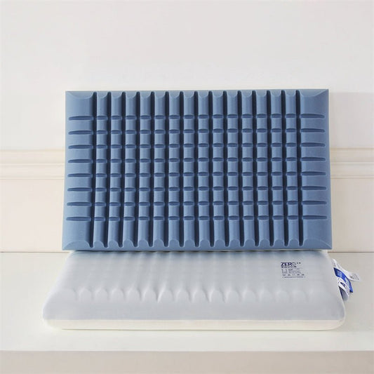 A blue memory foam pillow with a double layer carved design, displayed alongside its packaging.