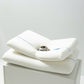 A white memory foam pillow with a contoured design, displayed on a neutral background.