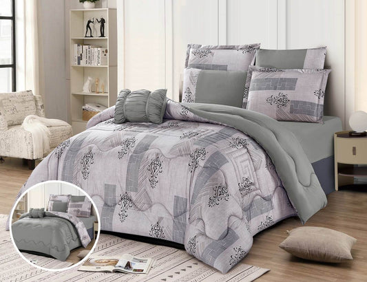 A graffiti-themed quilted summer comforter set displayed on a bed, with additional pillows and a comforter folded at the foot of the bed. The set features a geometric pattern in shades of gray and white.