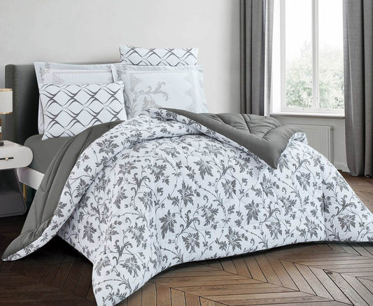 A bedroom set with a floral comforter in gray and white, with matching pillows and comforter cover.