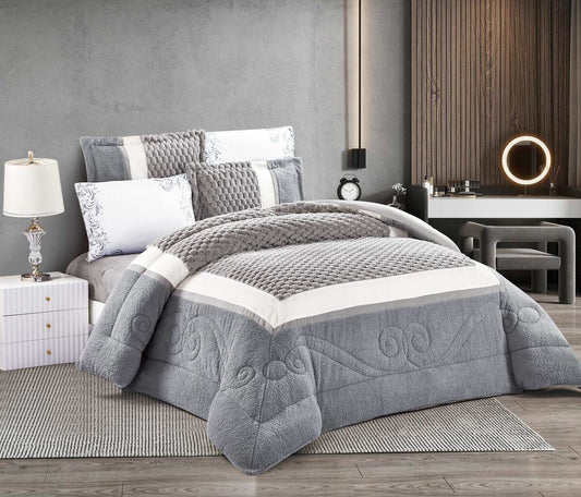 A color block thermal comforter set with a 3D quilted design, displayed on a bed in a bedroom setting. The set includes a grey and white comforter, two pillowcases, and a fitted sheet.