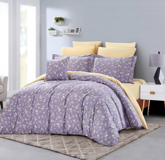 Bedroom with a bed covered in purple floral bedding and yellow pillows.