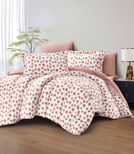Polka dot bedding set on a bed with a lamp and plant in the background.
