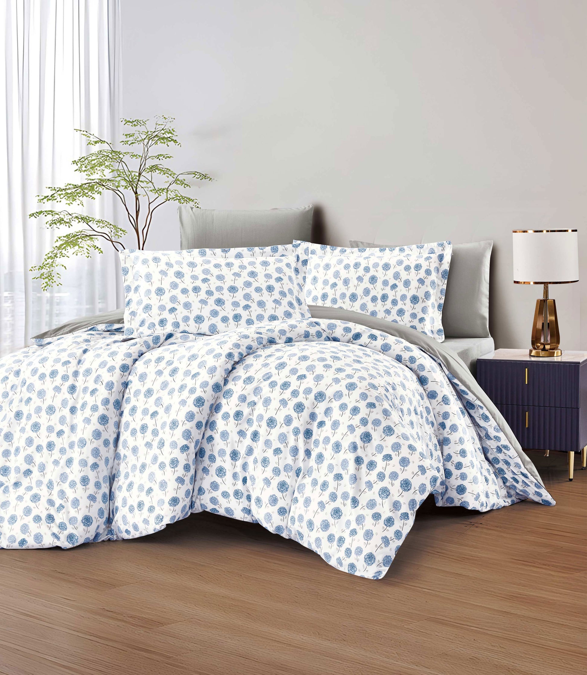 Blue and white polka dot bedding set on a bed in a bedroom.