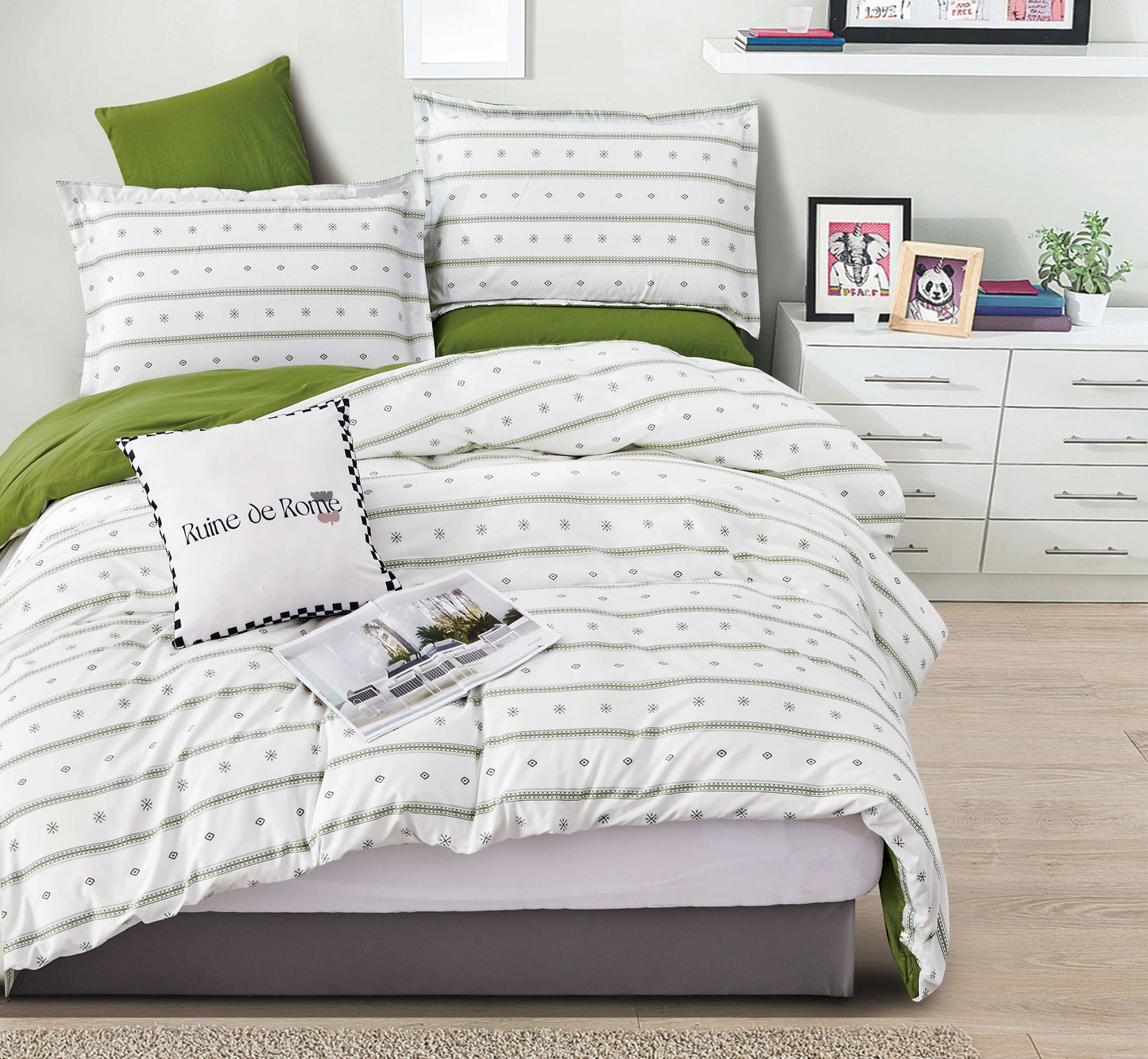Bedroom with striped bedding and green pillows on a bed.