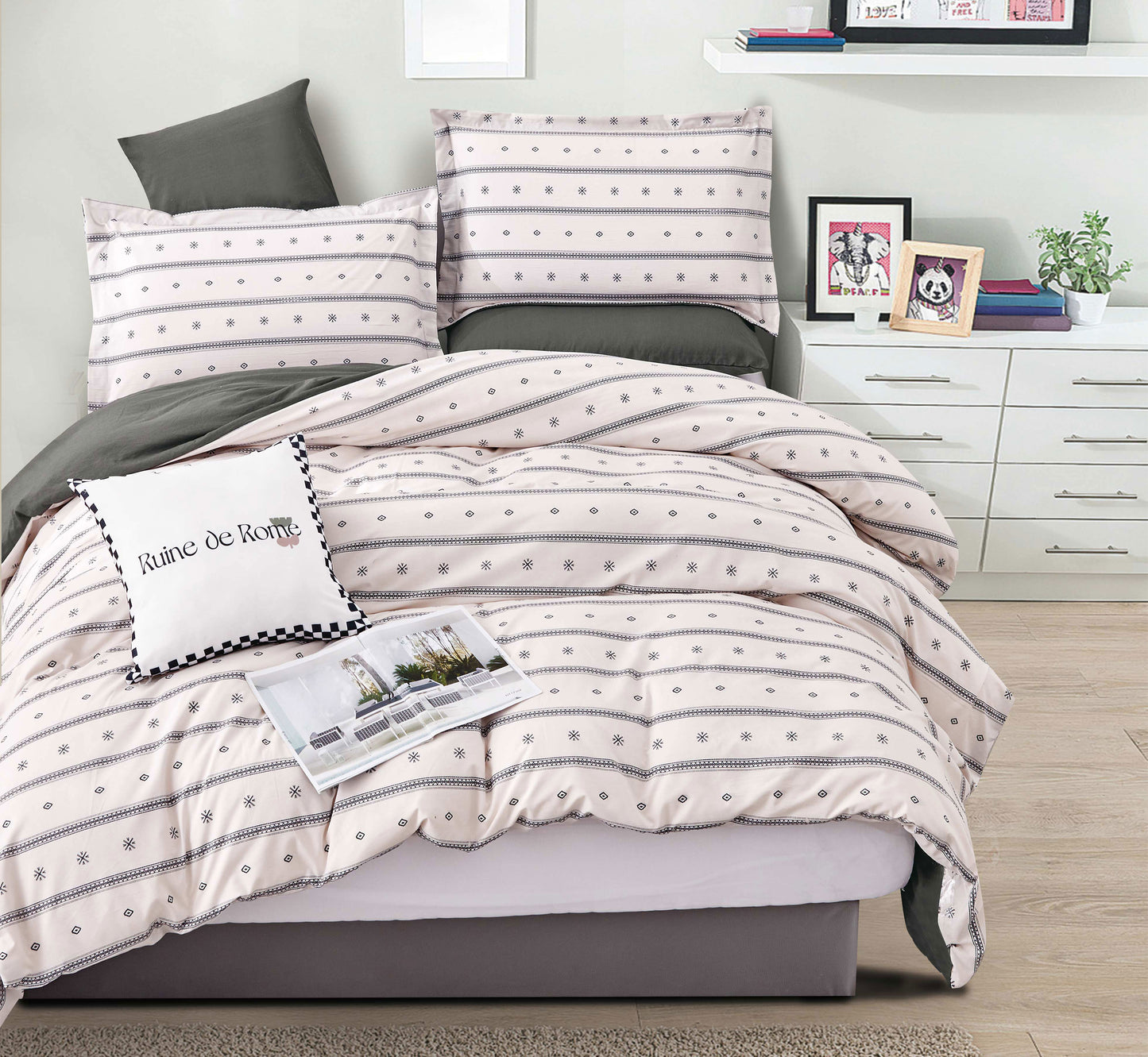 Bed with striped bedding and decorative pillows in a bedroom setting.