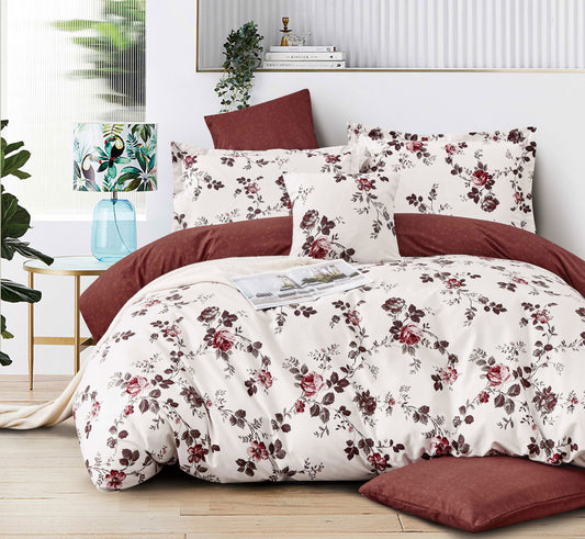 Floral bedding set on a bed with a red headboard in a bedroom setting.