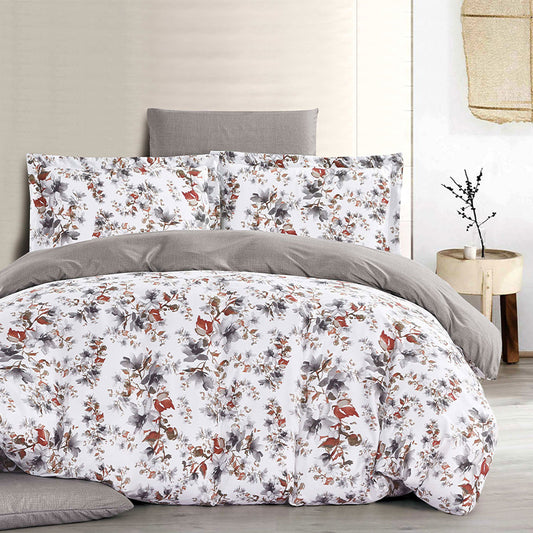 Floral bedding set with gray pillows on a bed in a bedroom setting.