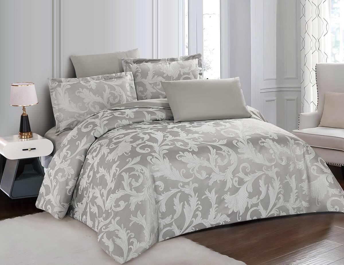 A gray bedding set with floral patterns, including a duvet cover and pillows, displayed on a bed.