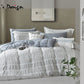 Bedding set with pillows and comforter on a bed, featuring Lei's Design branding.